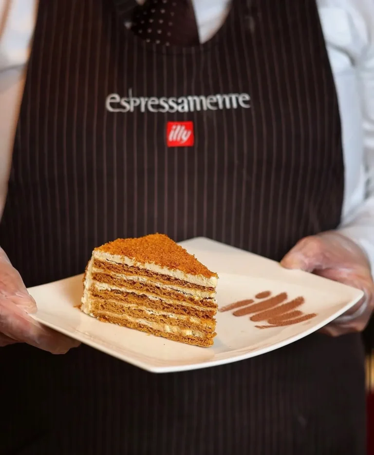 Server presenting layered cake — MICC International photography
