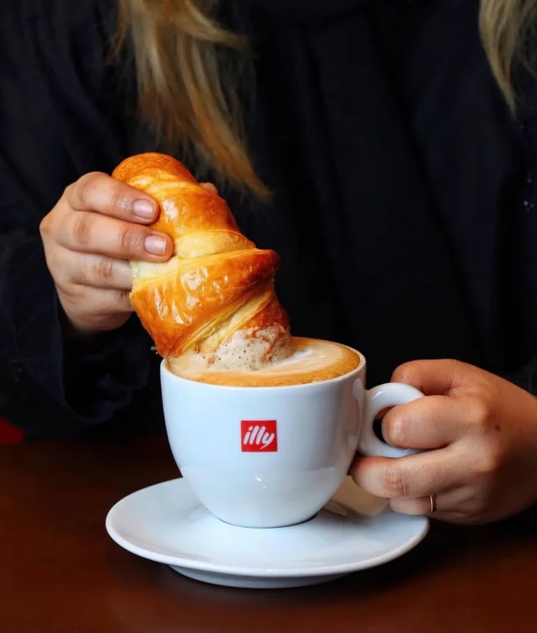 Croissant dipped in coffee — MICC International photography