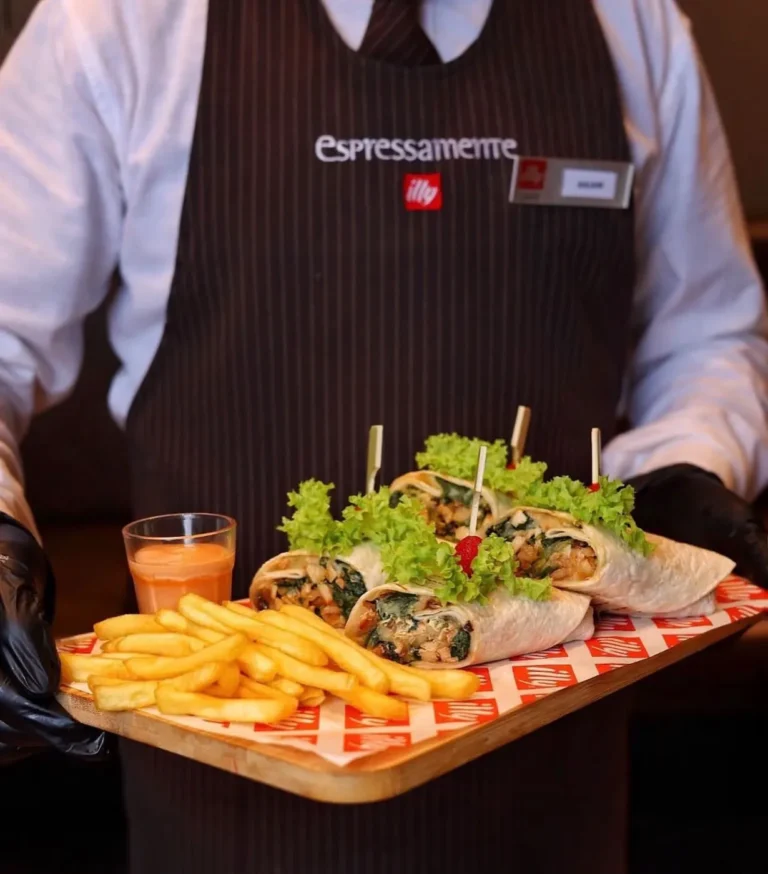 Server with sandwich and fries platter — MICC International photography