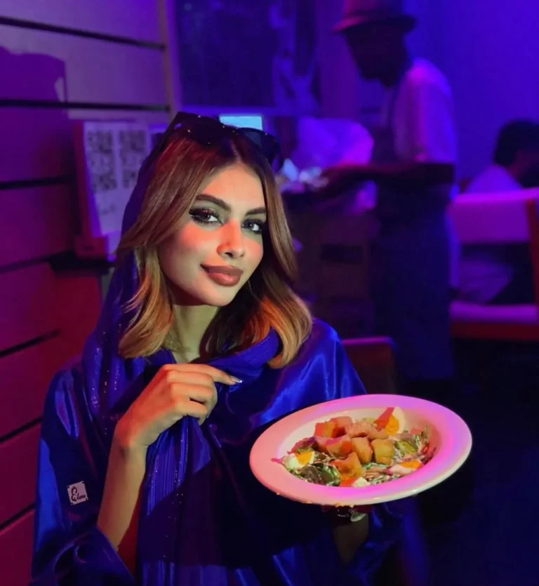 Model holding dessert under neon light — MICC International photography