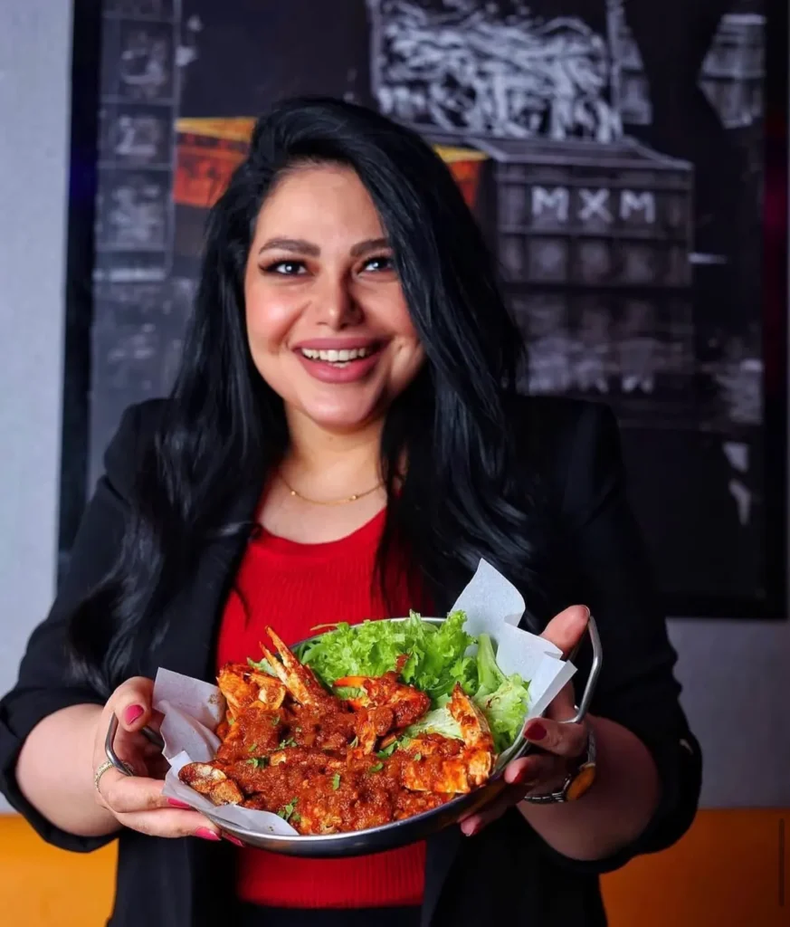 Guest holding a seafood dish — MICC International photography