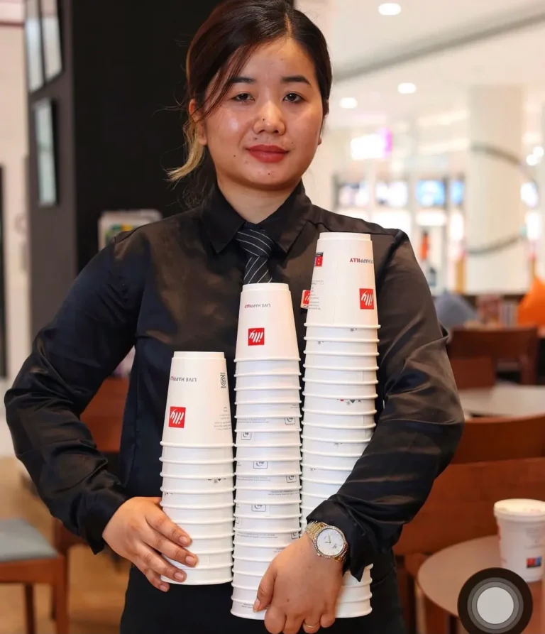 Barista with stacked illy cups — MICC International photography